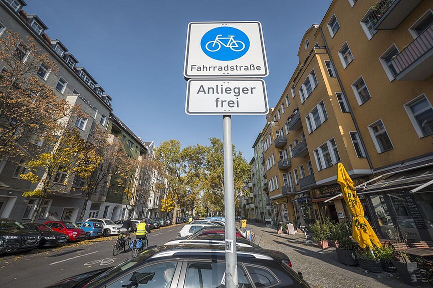 Fahrradstraße Blick auf ein Verkehrszeichen "Fahrradstraße" am Eingang einer Straße mit Wohnhäusern auf beiden Seiten.